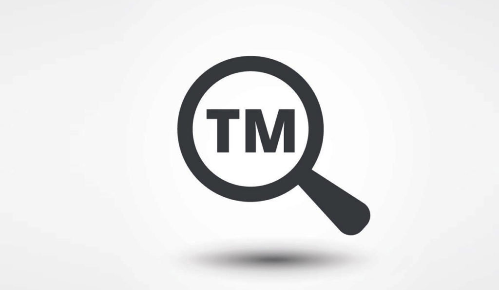 Trademark TM in magnifying glass