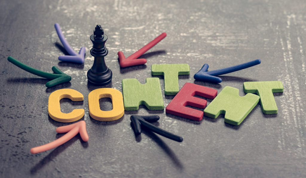 Letters spelling out content with arrows and King chess piece