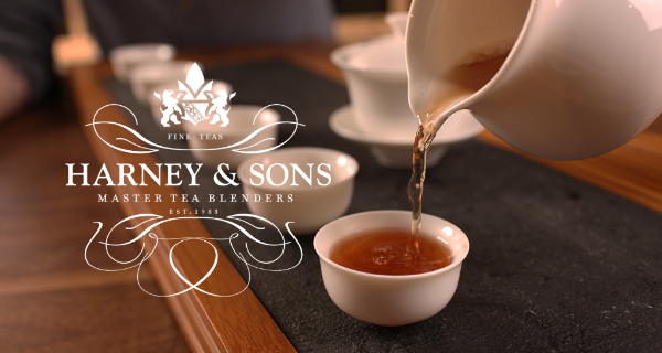 Harney logo over image of white teapot pouring tea into small cup.