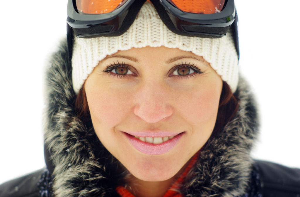 woman wearing fur-collar jacket and ski goggles