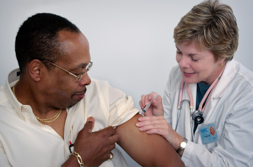 Doctor giving a shot to a patient
