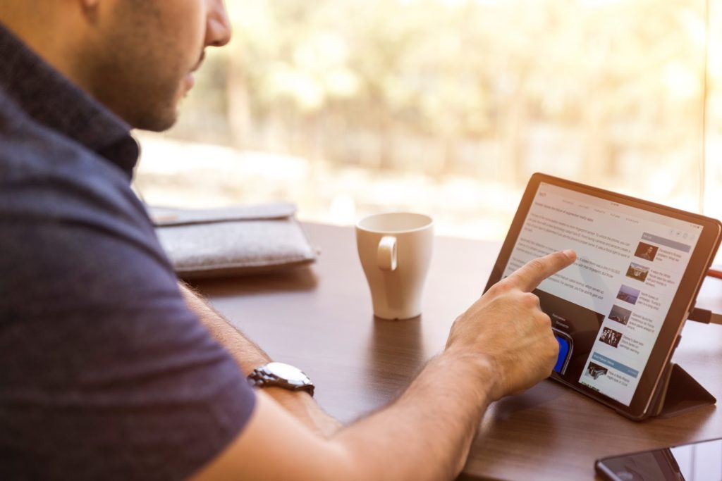 Man looking at a tablet screen