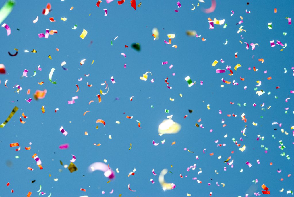 multi-color confetti falling on a blue background